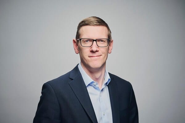 Professional head shot of Christopher Burgess, Director of Cyber at Markel International, wearing blue suit jacket and light blue dress shirt. He is quoted regarding cyber risk and Marketl's new program.