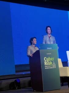 Neeti Bhalla Johnson presenting at the Zywave Cyber Risk Insights Conference in New York, discussing global trends in cyber insurance and cybersecurity.