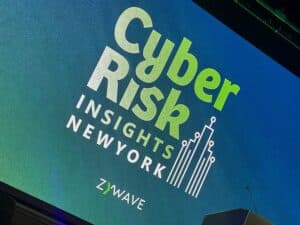 Stage display showing “Cyber Risk Insights New York” presented by Zywave at the 2025 conference, highlighting topics in cyber insurance and cybersecurity.