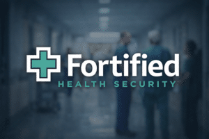 Fortified Health Security logo over a hospital hallway with clinical staff, illustrating healthcare cybersecurity resilience and operational protection.