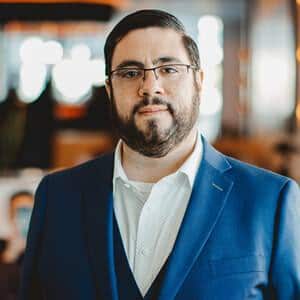 Francisco Donoso, Chief Product and Technology Officer at Beazley Security, wearing glasses and a blue blazer, in an indoor setting.